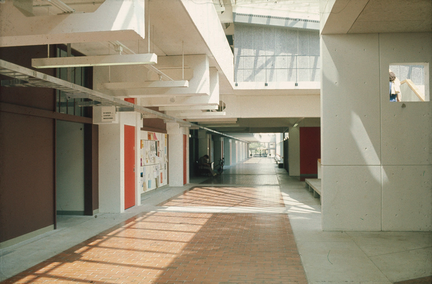 View down light-filled interior corridor.