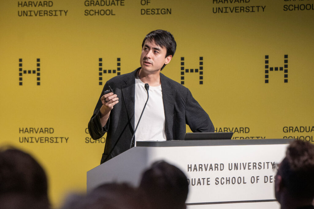 A man speaks at a podium at Harvard GSD.