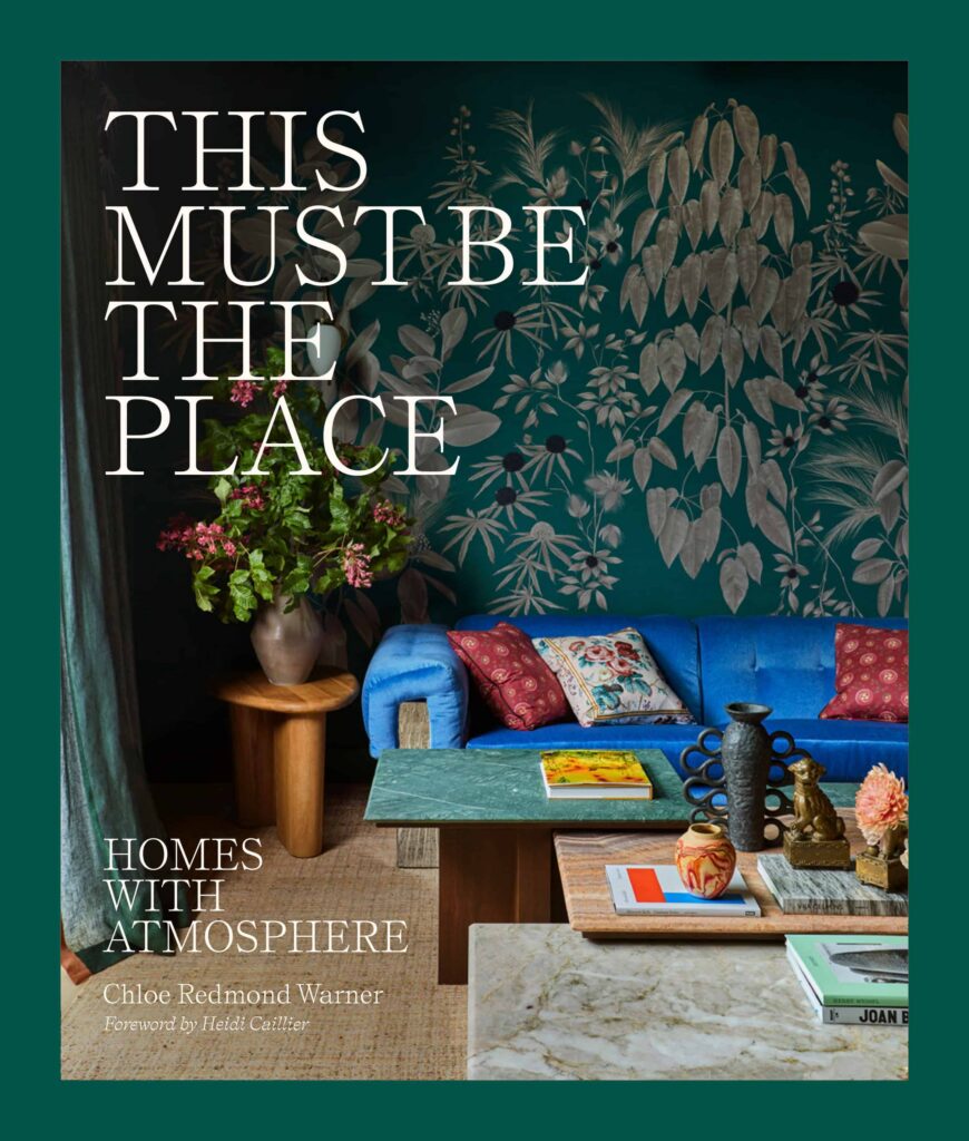 Green book cover featuring a photo of a carefully designed interior space with green floral wallpaper. The cover reads "THIS MUST BE THE PLACE."